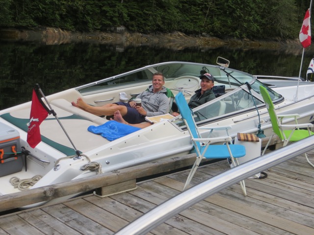 Dave Siegfried and Tyler Wilson aboard a 23ft Mirage tied to the dock at Princess Louisa Inlet, British Columbia.